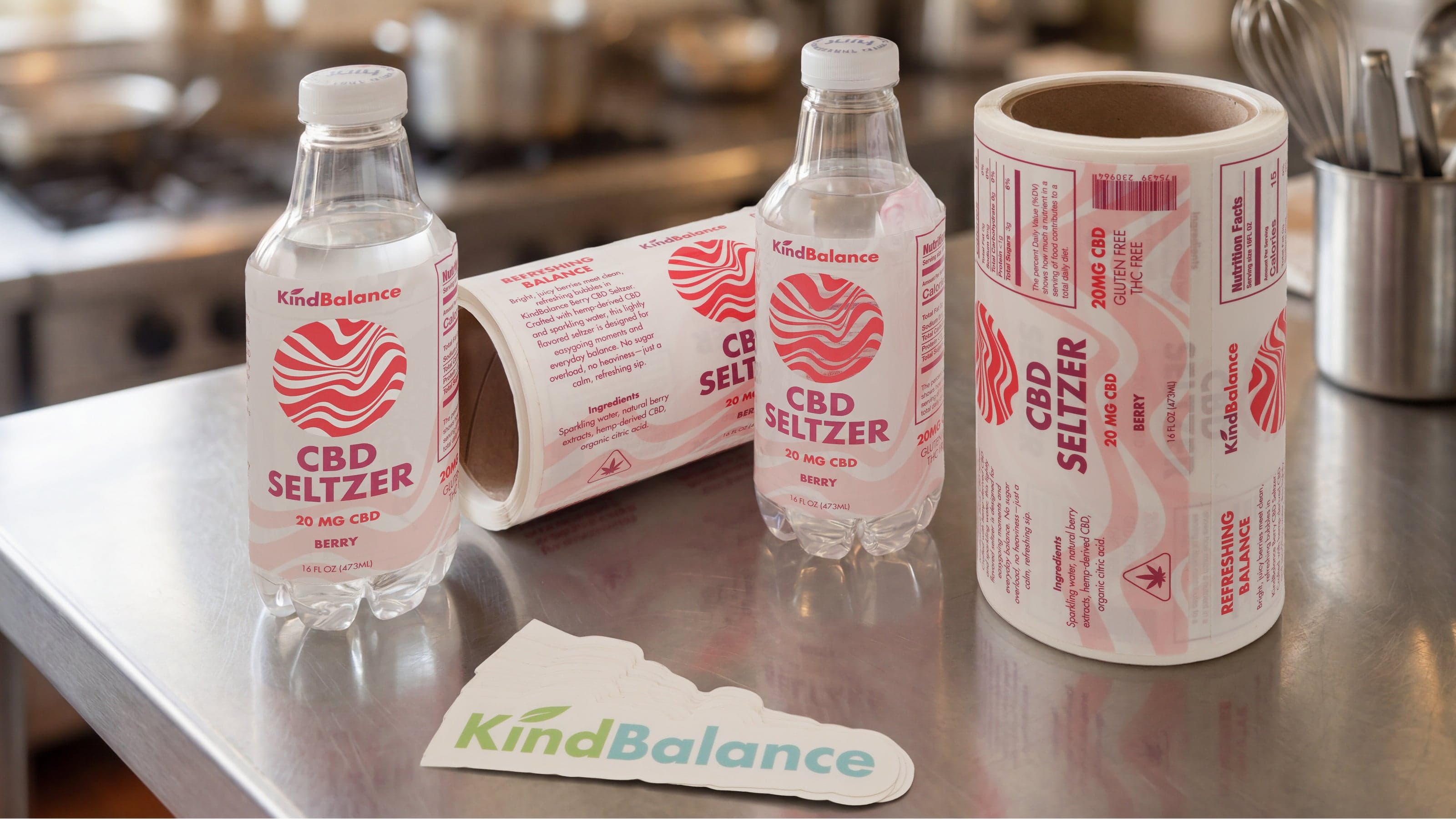 CBD seltzer bottles, printed label rolls, and custom die cut stickers displayed together.