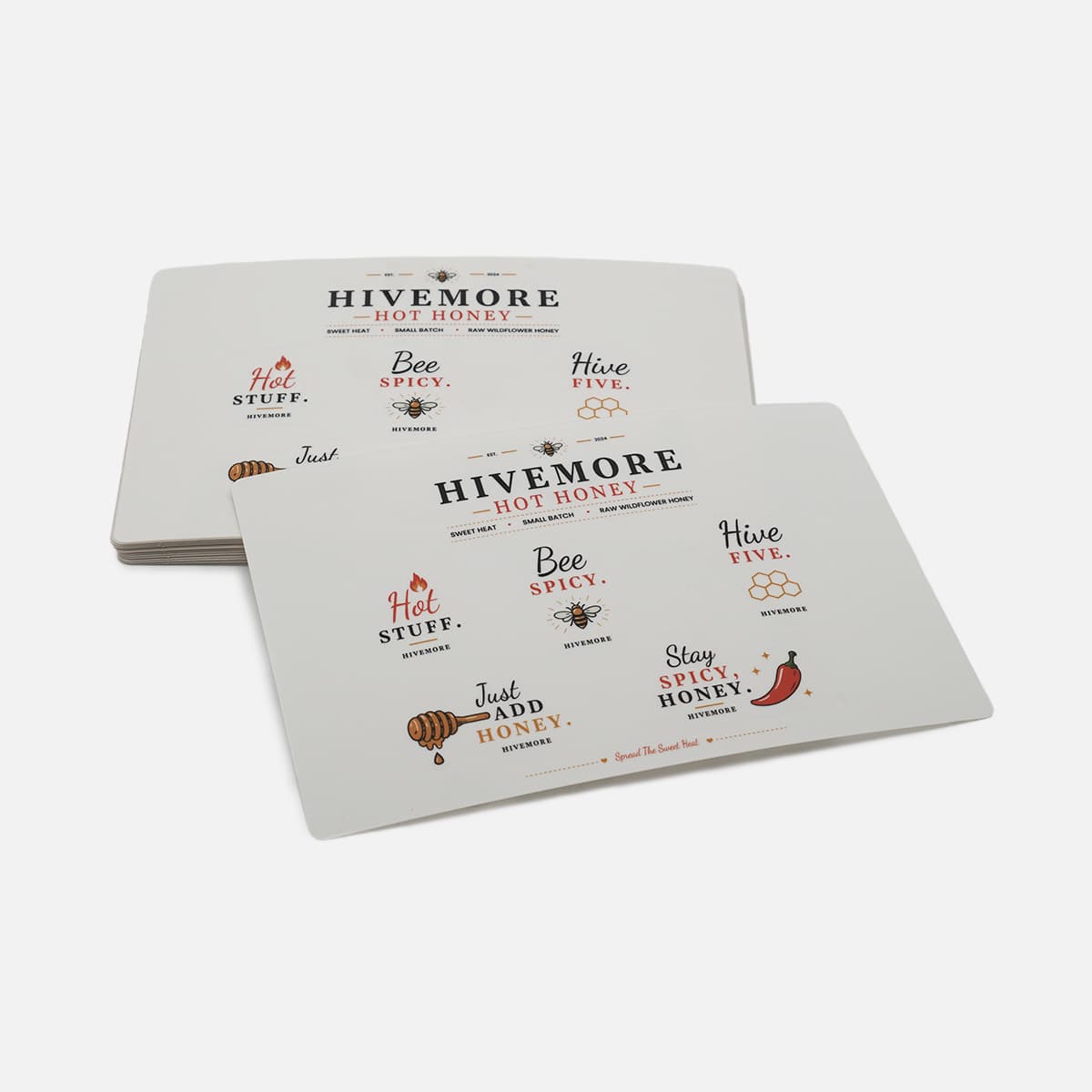 Clear sticker sheet featuring custom food and beverage branding stickers for hot honey packaging, including logo stickers, product labels, and promotional designs printed on transparent material.