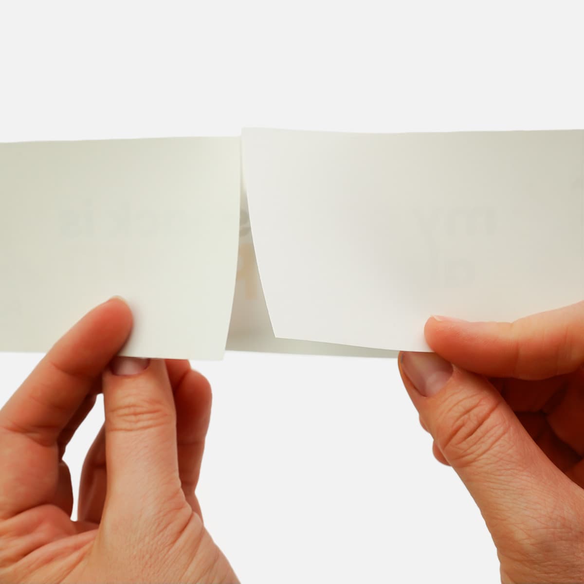 Split-back bumper sticker liner showing easy peel-and-apply backing for quick sticker application on vehicles, windows, and equipment.