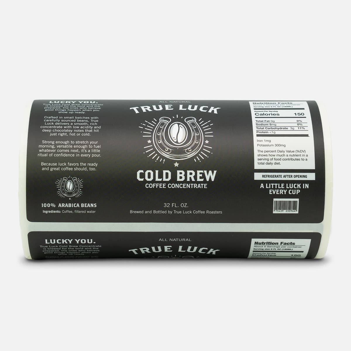 Roll of custom True Luck Cold Brew Coffee Concentrate labels featuring black packaging artwork with nutrition facts, barcode, and horseshoe coffee bean design.