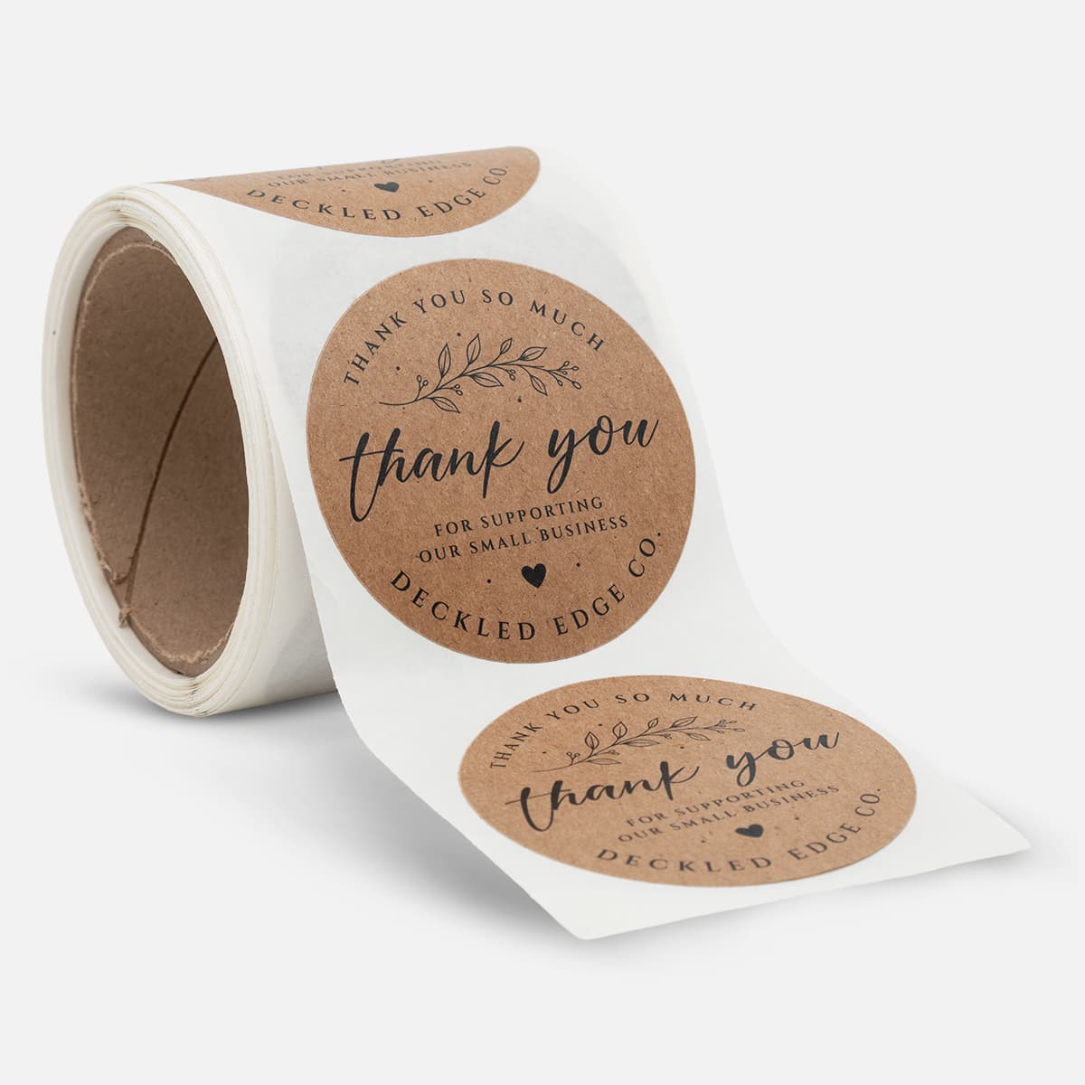 Roll of round kraft thank you labels for Deckled Edge Co. with black floral artwork and small business support text.