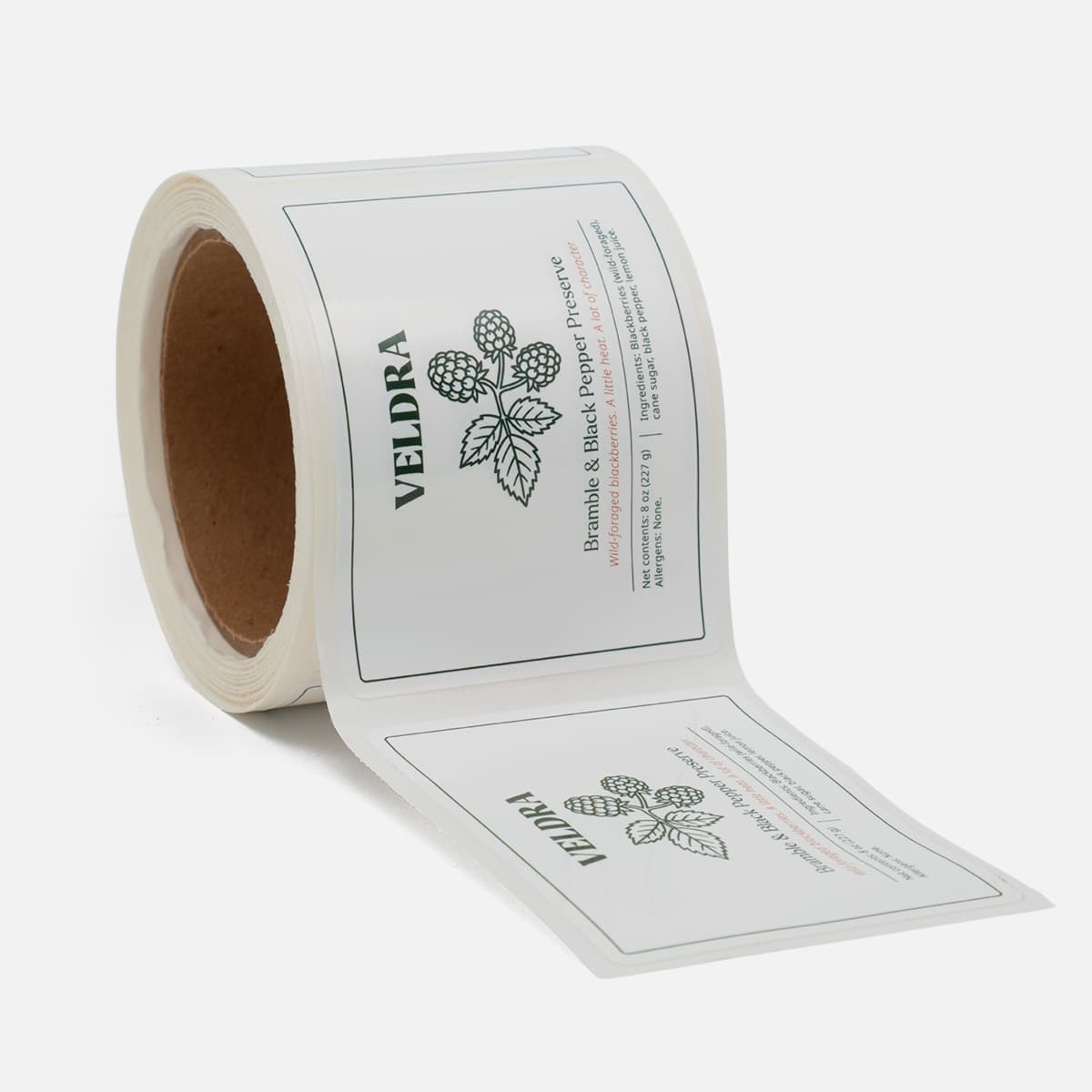 Roll of custom Vedra preserve labels featuring Bramble and Black Pepper Preserve artwork with blackberry illustrations and clean green accents.
