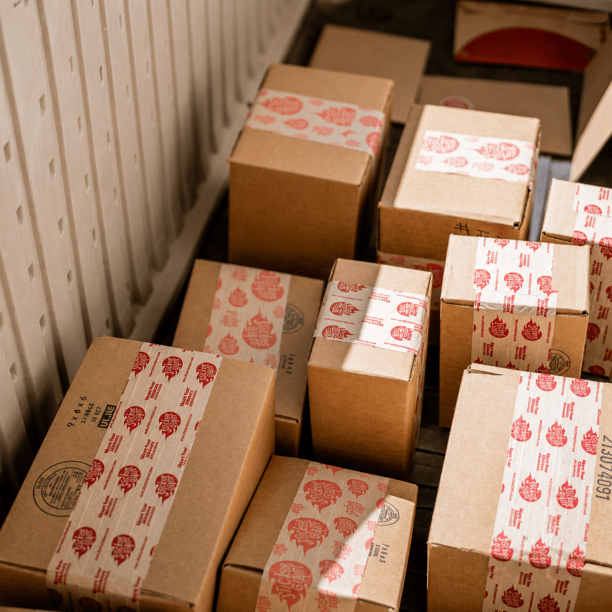 StickerGiant customer orders packaged in recyclable cardboard shipping boxes.