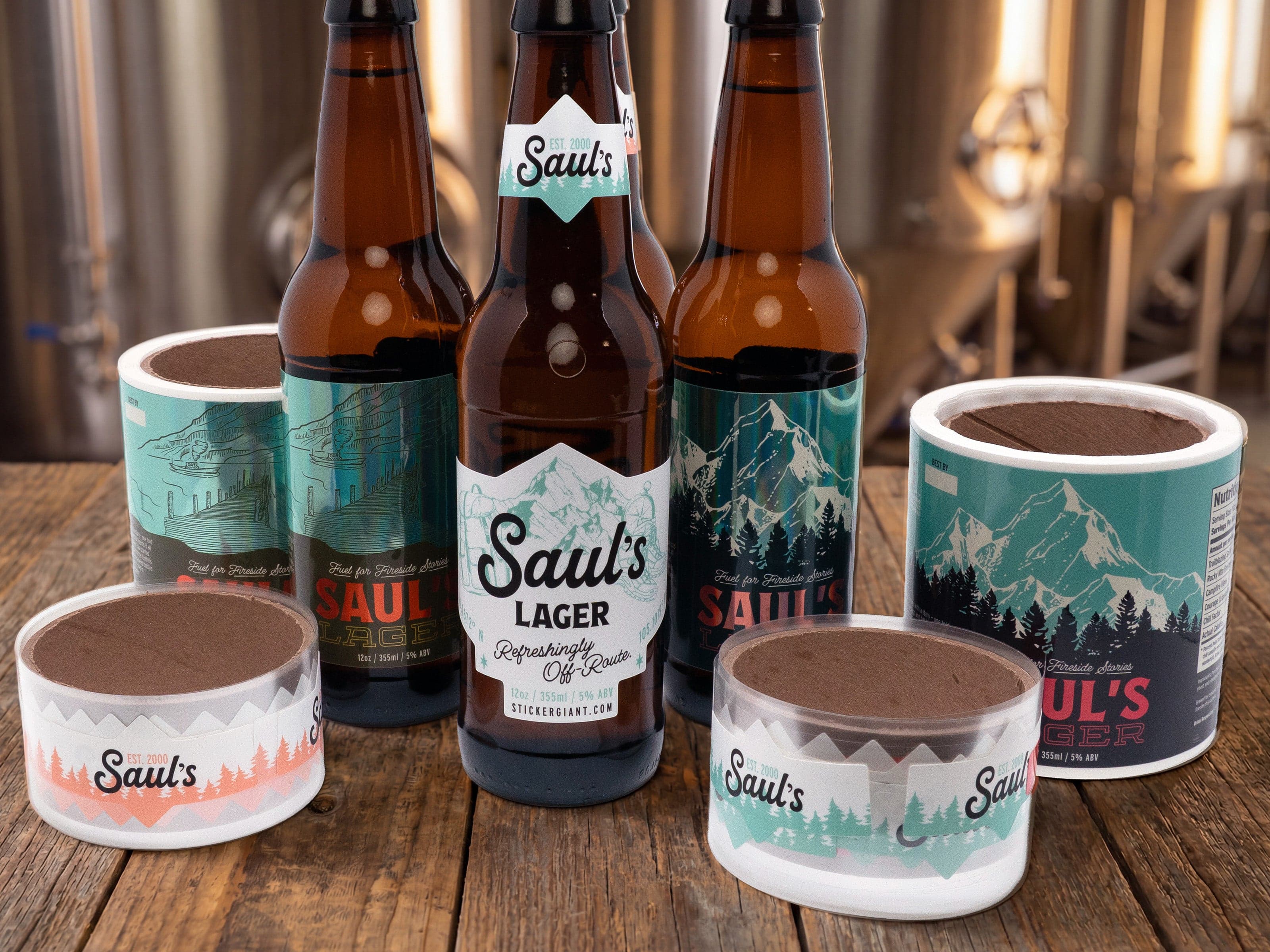 Custom craft beer bottle labels and PET-backed label rolls displayed in a brewery, featuring durable beverage labels designed for machine application and high-volume packaging.