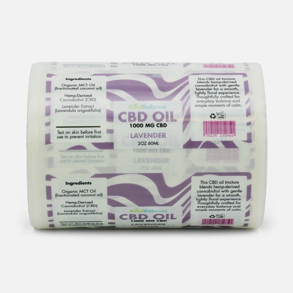 Roll of custom CBD oil labels for KindBalance Lavender with purple patterned artwork, ingredient details, and barcode panels.