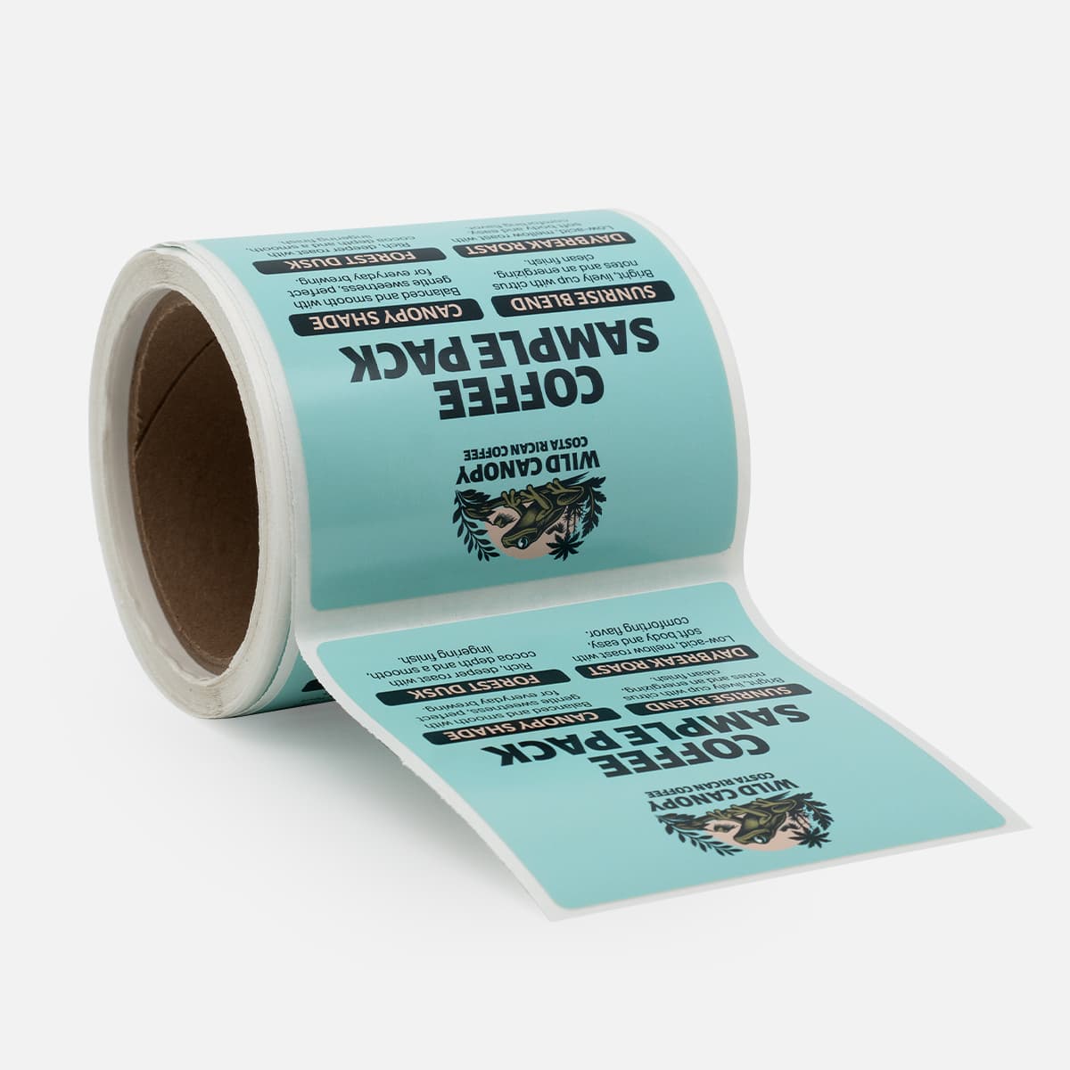 Roll of teal Wild Canopy coffee sample pack labels featuring flavor notes, roast names, and Costa Rican coffee artwork.