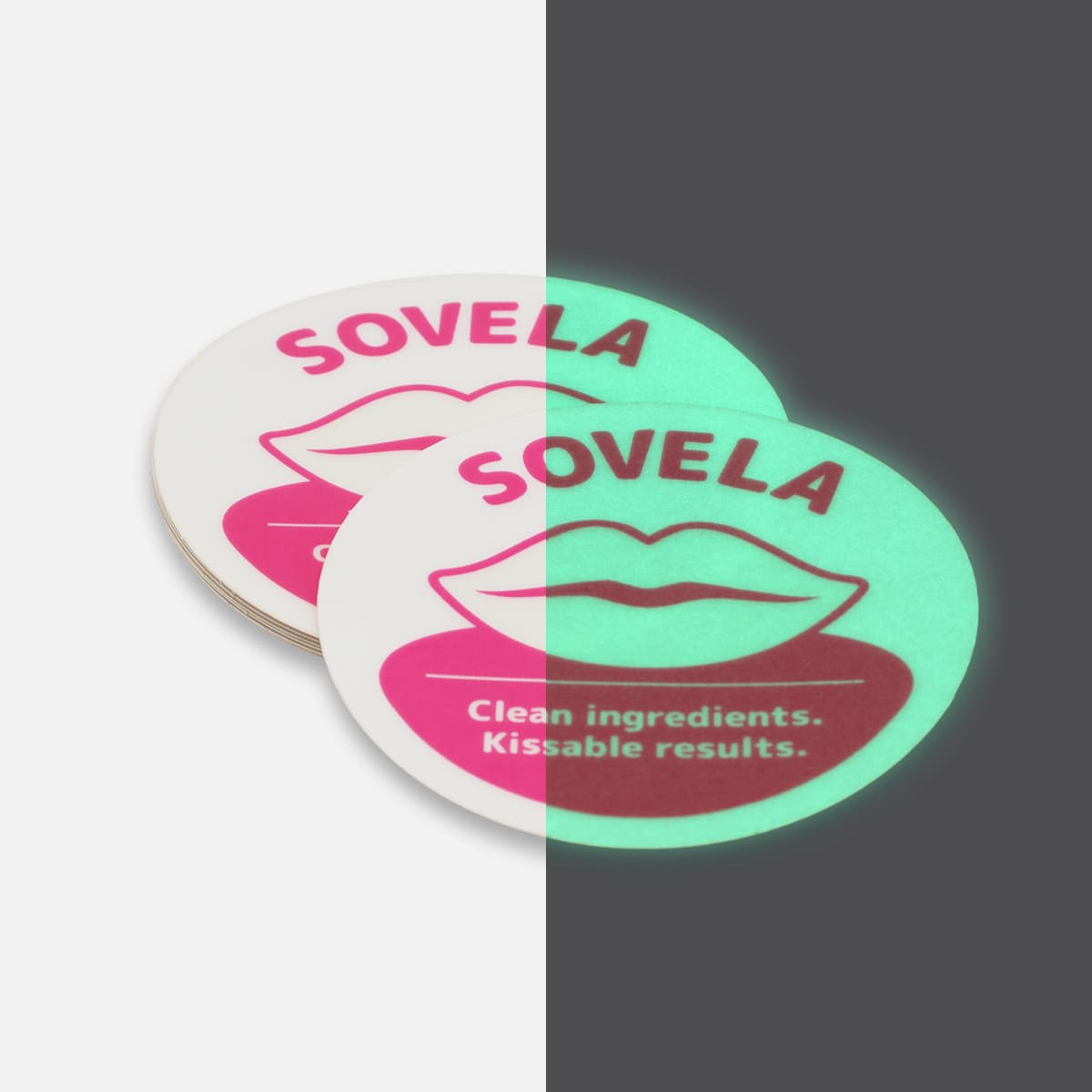 Round Sovela glow in the dark stickers shown half in daylight and half glowing green in the dark.