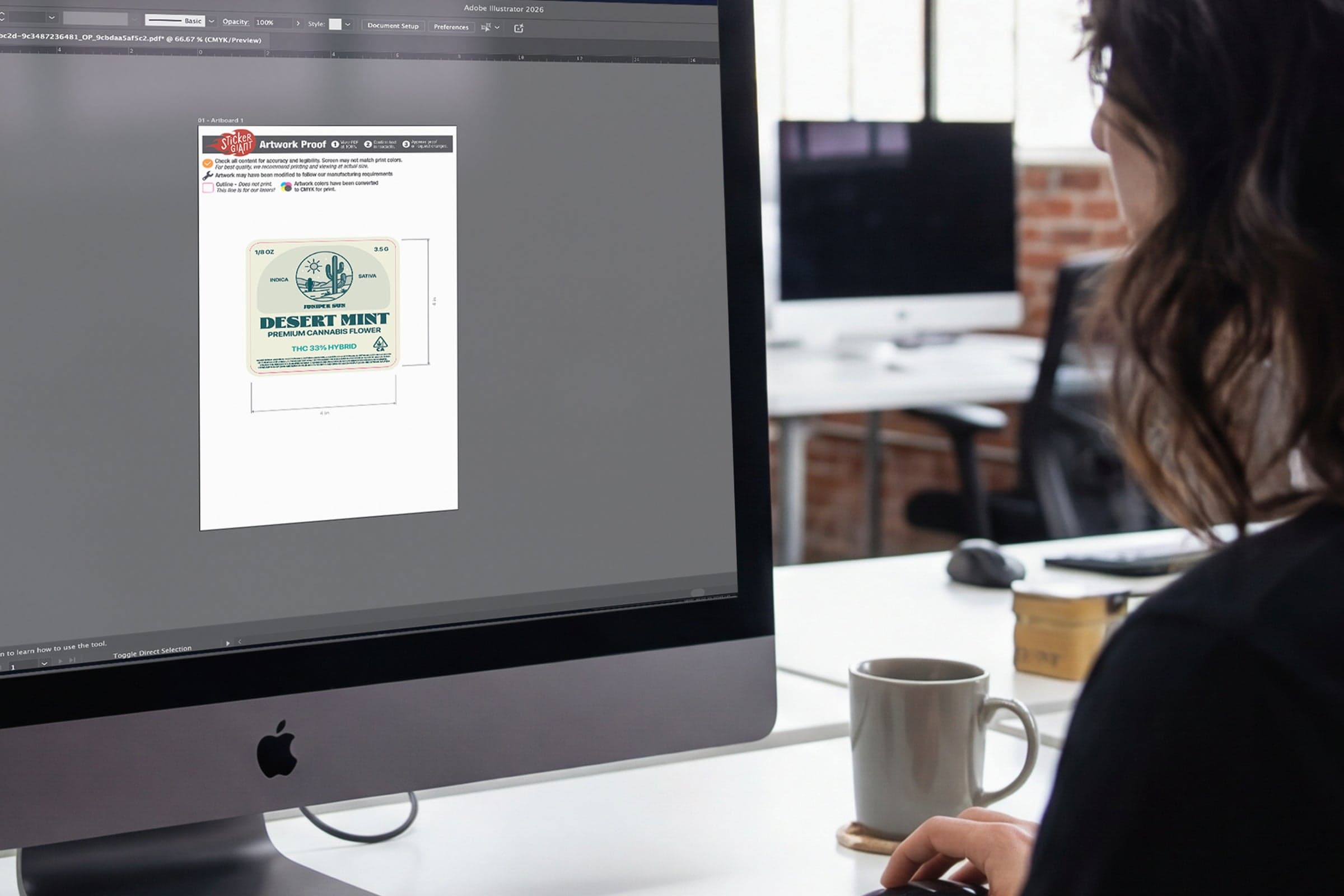 Designer reviewing a cannabis product label proof on a computer screen before printing.