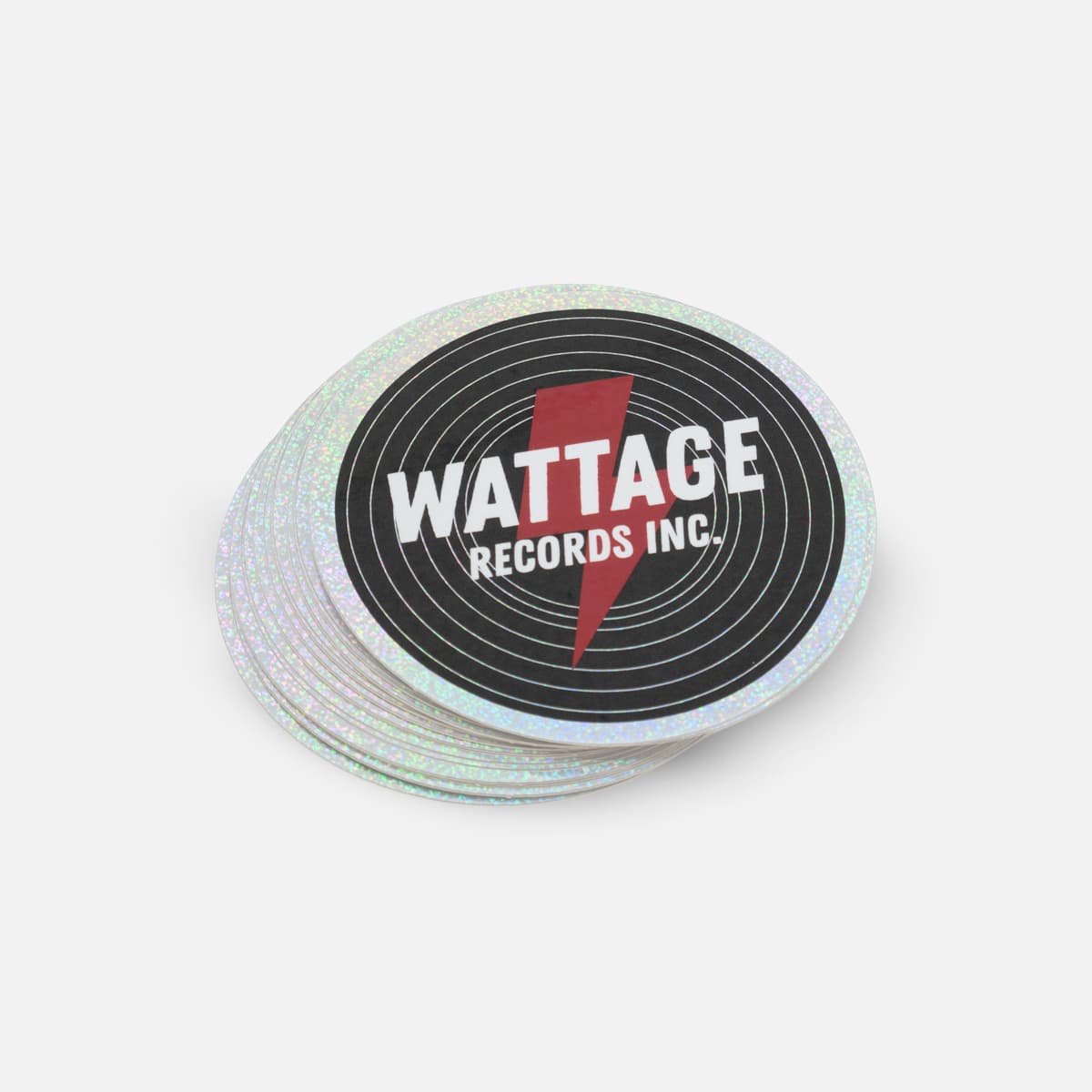 Stack of custom round glitter stickers for Wattage Records featuring holographic glitter material and bold record label branding.